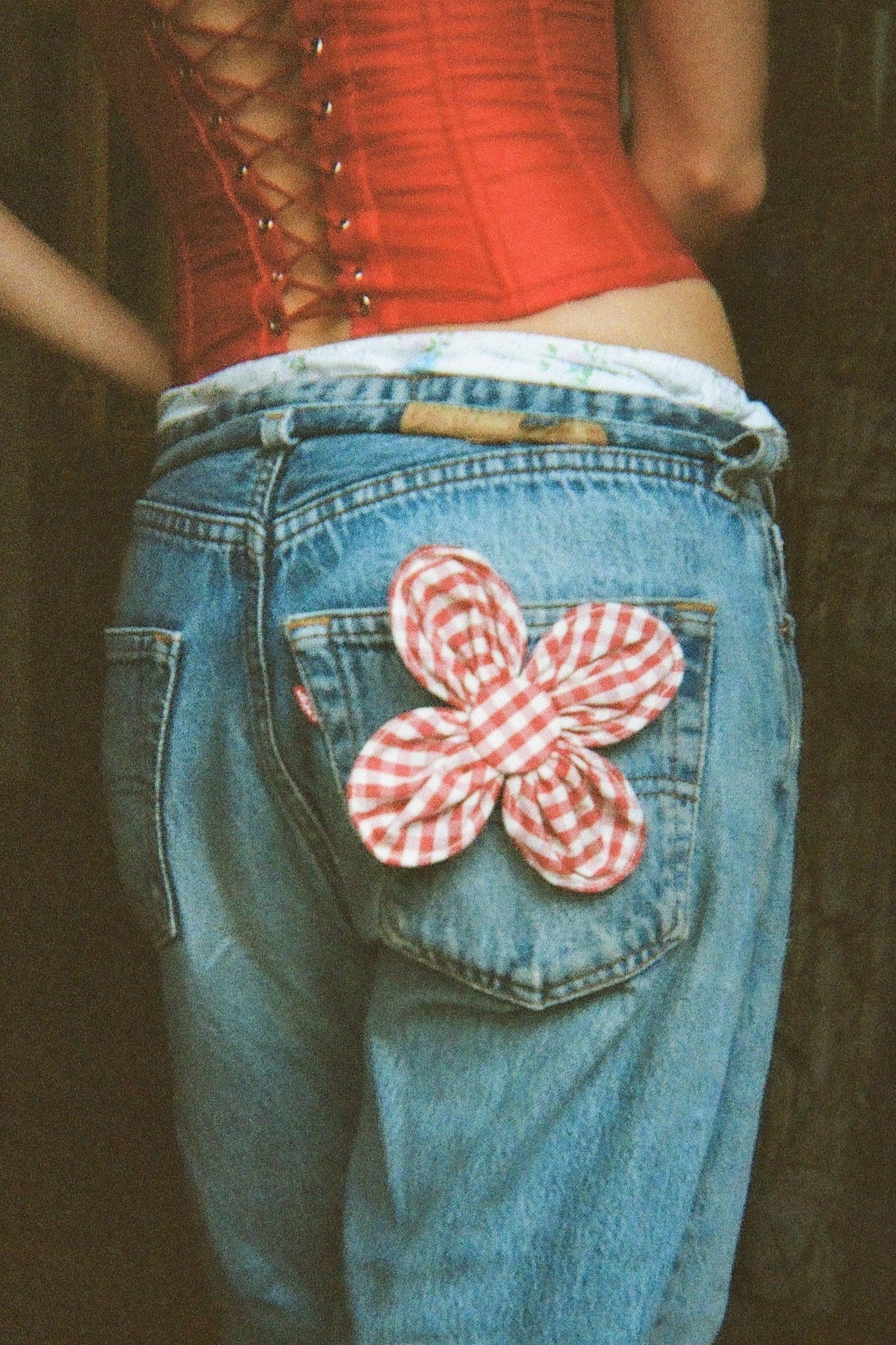 Bloom Brooch 12 cm red Small flower brooch is handcrafted from off-cut fabric. Each petal has sewn in wire around the edges, allowing them to be shaped after desire. Made in Denmark. Materials: 100 % organic cotton yarn dyed gingham, viledon, metal wire and nickel free brooch back · Collection: Gingham Garments. LINÉ