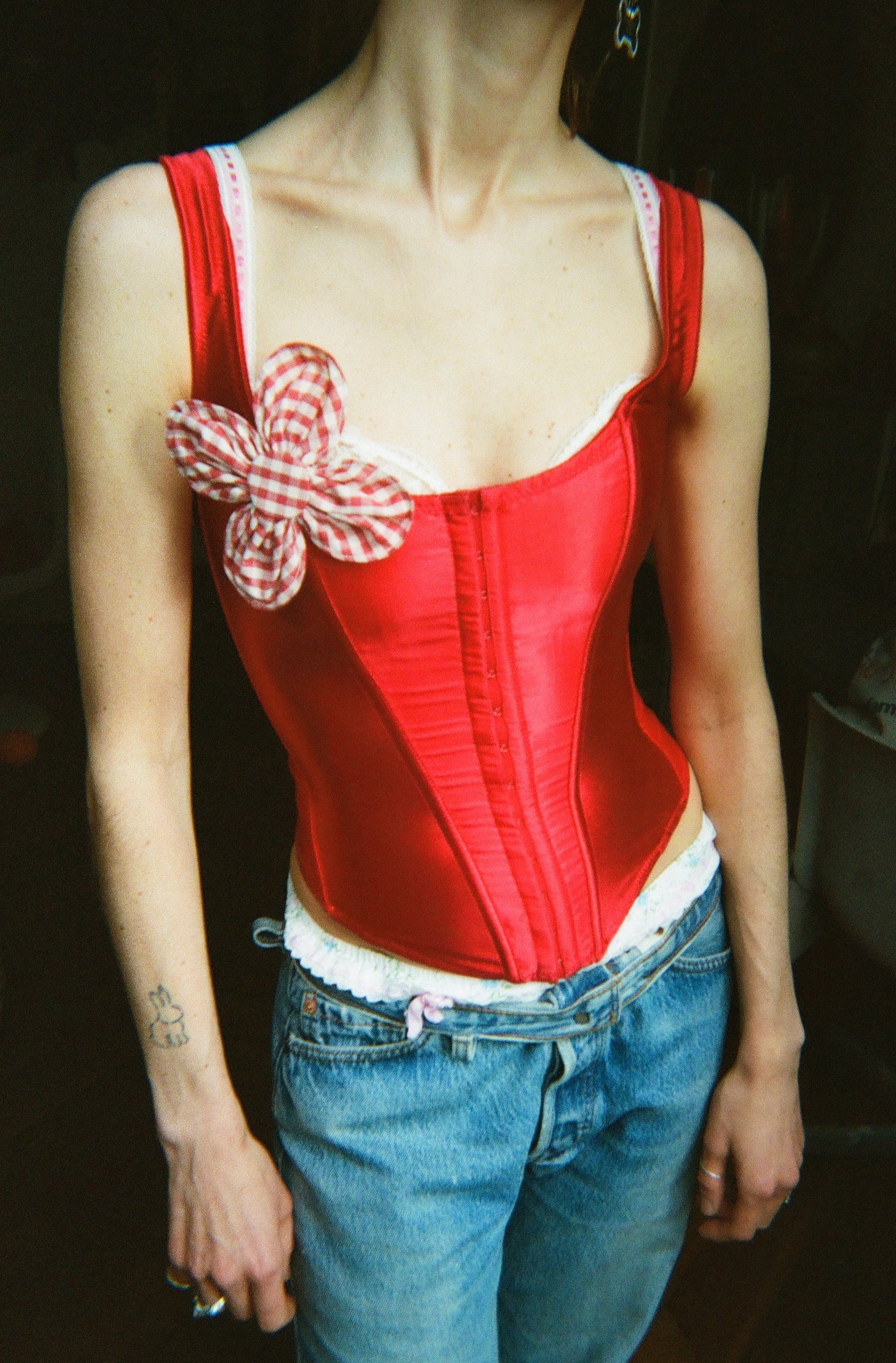 Bloom Brooch 12 cm red Small flower brooch is handcrafted from off-cut fabric. Each petal has sewn in wire around the edges, allowing them to be shaped after desire. Made in Denmark. Materials: 100 % organic cotton yarn dyed gingham, viledon, metal wire and nickel free brooch back · Collection: Gingham Garments. LINÉ