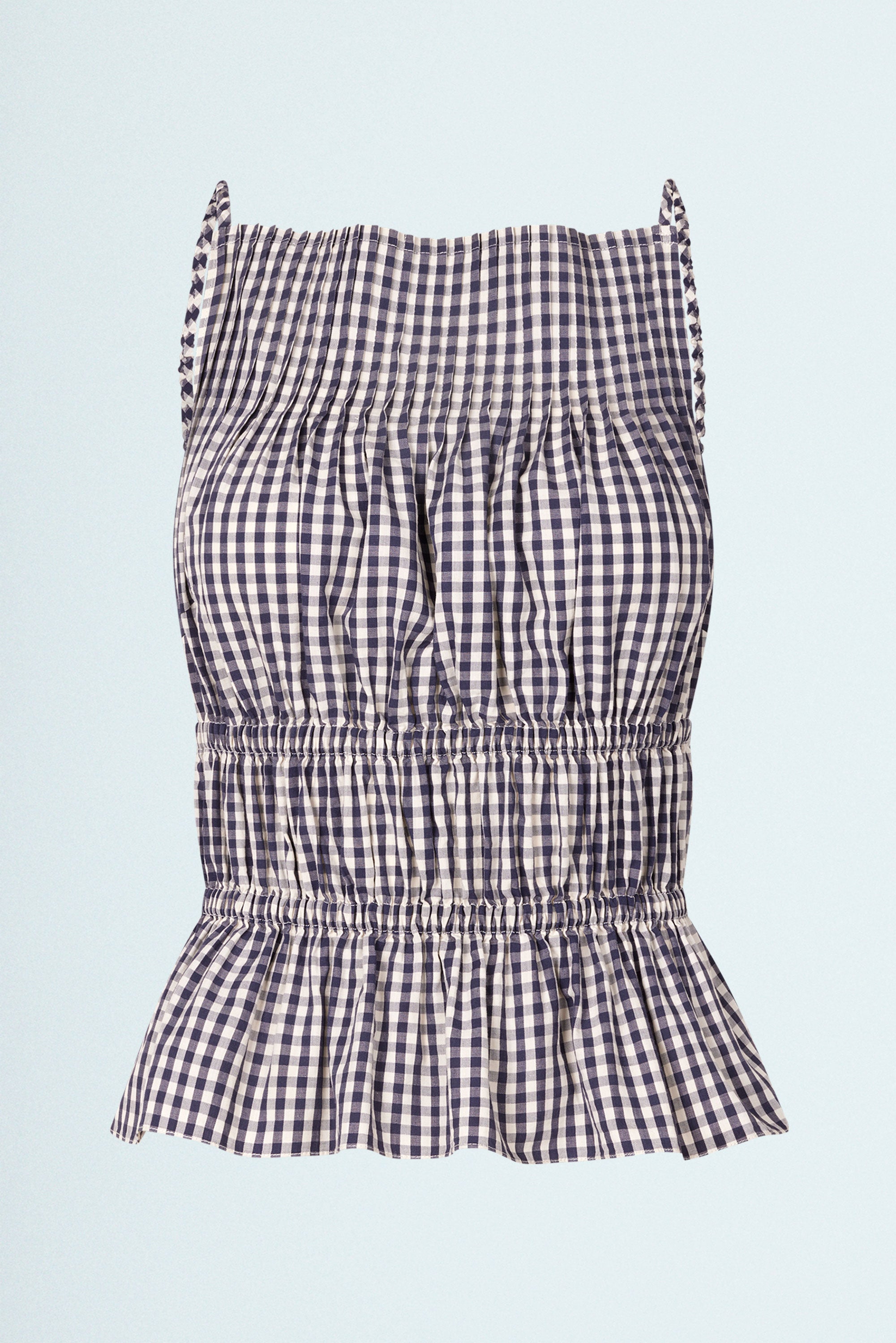 LINÉ Pintuck Top Navy. Pintucks at neckline · Elastic shoulder straps · Elastic casing under the bust and around the waist · Low back · The back hem is slightly elongated and is separated from the front by a small slit in the side seams · Model is 162 cm and wears size 1 · Made-to-order · Produced locally in Denmark · Material: 100 % organic cotton yarn dyed gingham · Collection: Gingham Garments. LINÉ